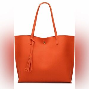 Large orange faux leather tote handbag.